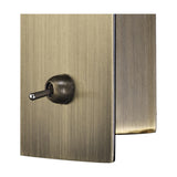 Close-up of the Winslow Oval Wall Light in antique brass, showing the toggle switch and side profile of the rectangular wall plate on a plain background.
