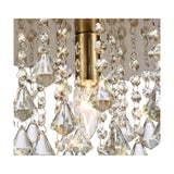 Close-up of the Acton E14 round flush ceiling light, 25cm, showing an antique brass fitting with a lit candle bulb surrounded by hanging clear crystal strands and faceted drops.