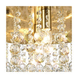 Close-up of the Acton 5 Light E14 Round Flush Ceiling Light in antique brass, showing clear crystal spheres and beaded strands illuminated by candle bulbs.