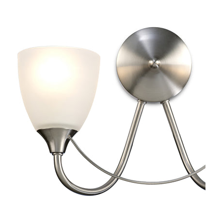 Cooper 2 Light E14 Wall Light in satin nickel, shown close-up with one lit opal glass shade and a round wall mount joined by curved arms, on a plain white background.