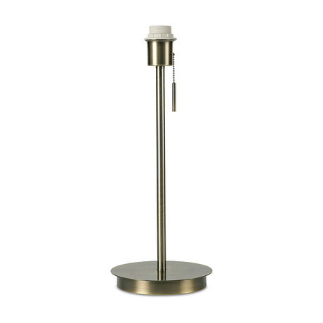 Carlton E27 Table Lamp 18cm in antique brass with a round flat base, slim upright stem, pull-cord switch and E27 lampholder, shown on a plain white background.