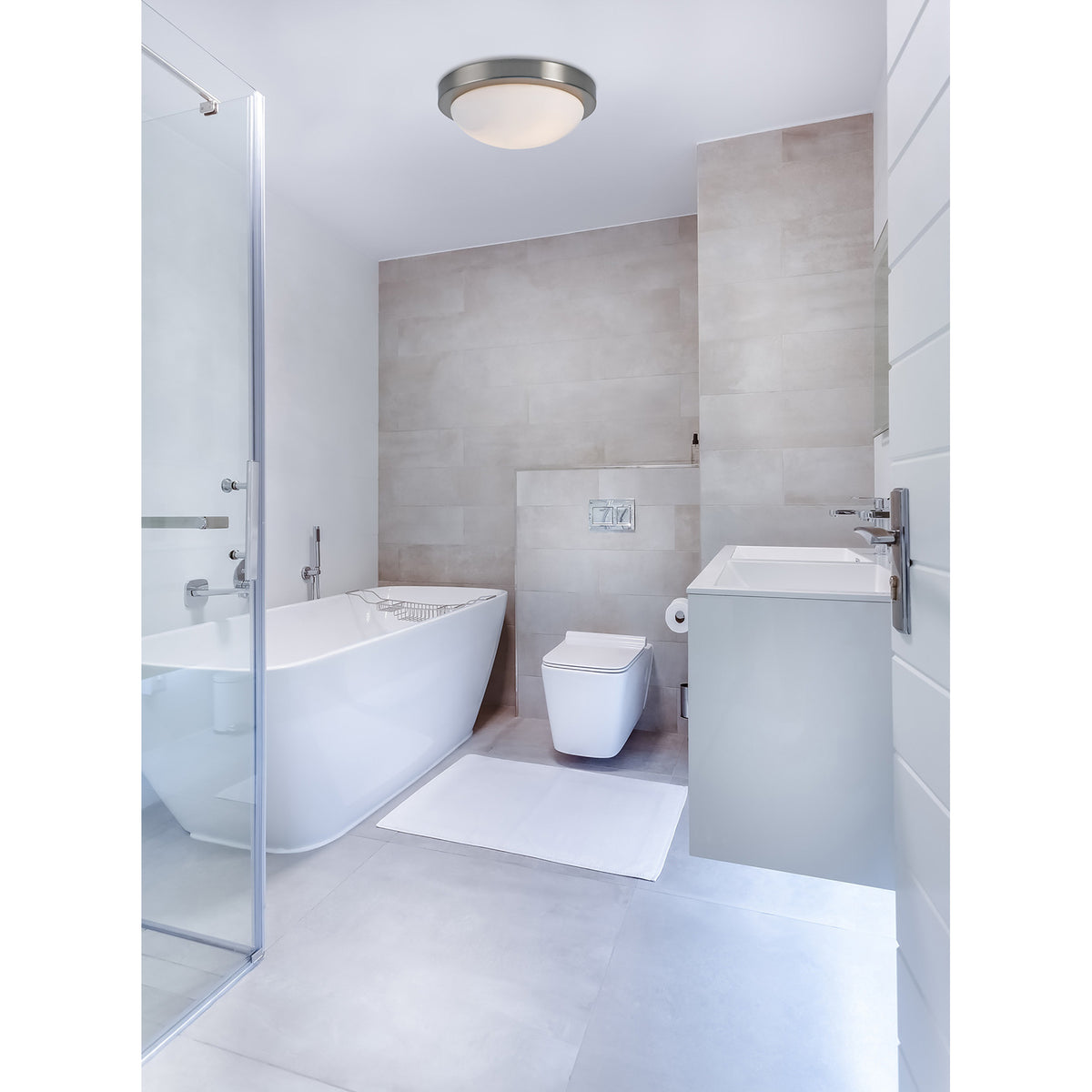 Porter 2 Light E27 Flush Ceiling Light 32cm in satin nickel with opal white glass dome, fitted to the ceiling of a modern bathroom with freestanding tub and vanity.