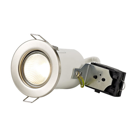 Agni Downlight in satin nickel with a round fixed bezel, GU10 lamp lit warm white, and attached metal mounting clip, shown on a plain white background.