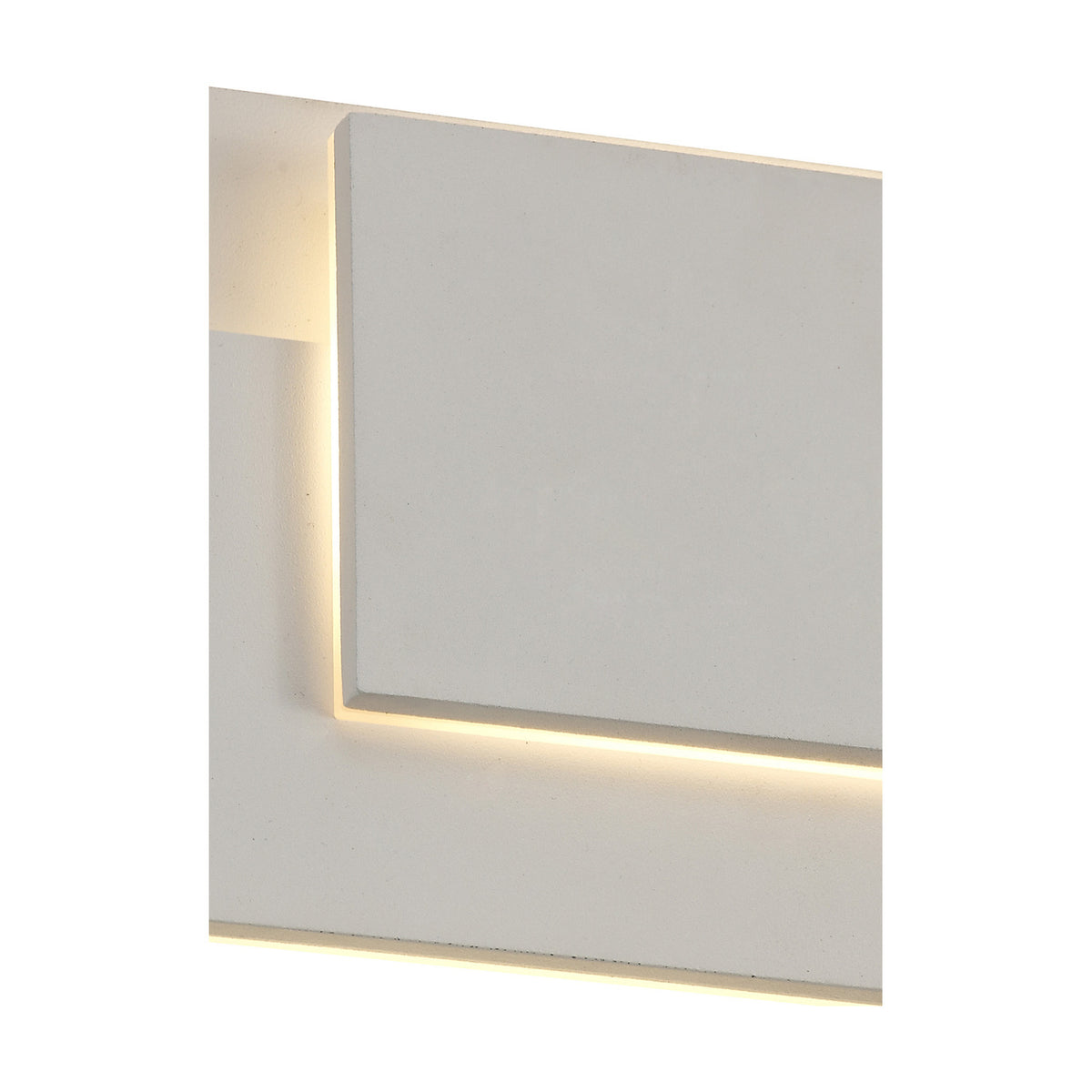 Close-up of the Kiania Rectangular Wall Light in sand white, showing the flat square panel with a soft warm white LED glow along its top and bottom edges against a plain background.