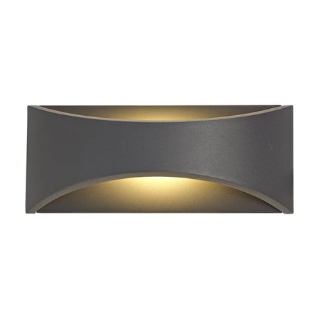 Aryana 6W IP54 outdoor wall light, 22cm rectangular anthracite aluminium body with curved cutouts casting warm white glow up and down, shown on a white background.