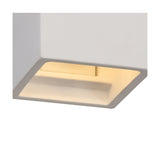 Alina G9 square wall light in white paintable gypsum, recessed into a white wall corner with warm downward light through an angled slot opening.
