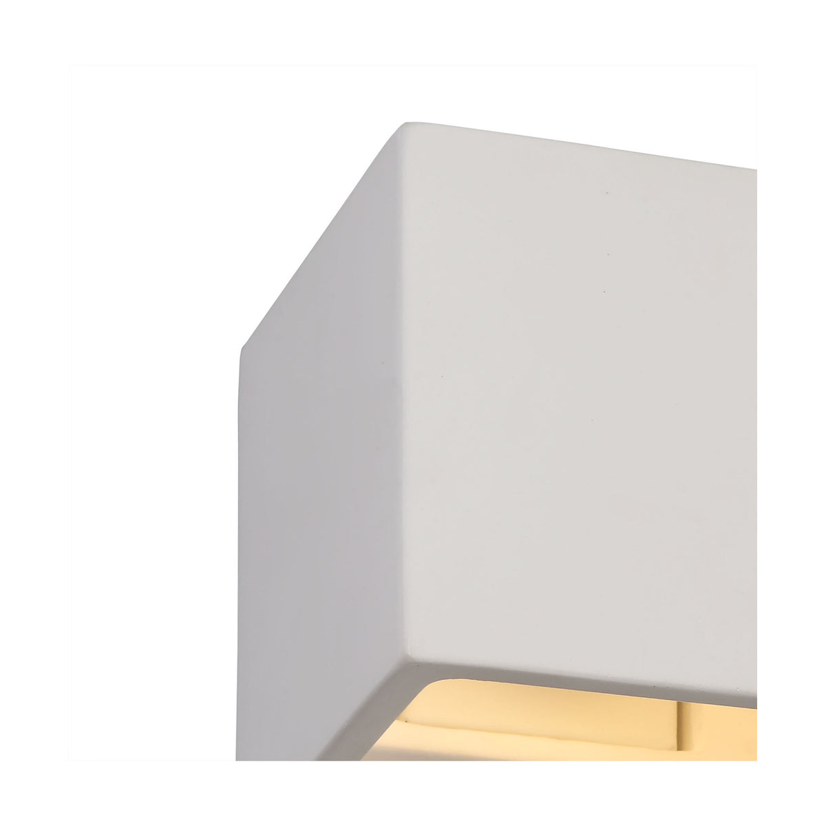 Close-up of the Alina G9 Square Wall Light, a small square white gypsum cube fitting with a paintable matte finish, downward light glow visible at its base, shown against a plain white background.