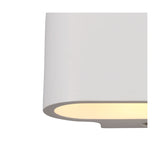 Close-up of the Alina G9 Oval Wall Light in white paintable gypsum, showing its smooth curved edge and downward light spill against a plain white background.