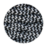 Close-up of Cavo Wave Stripe Braided Twisted Cable, a fine 2-core fabric flex in black with a white wave pattern spiralling along its tightly woven twisted cores.