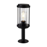 Reva IP44 E27 lamp post light with black aluminium body and clear polycarbonate cylindrical head, lit ST64 bulb visible, on a round pedestal base, plain white background.