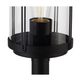 Close-up of the Reva IP44 E27 lamp post head in black aluminium with a clear polycarbonate cylinder, vertical bar detailing, and an exposed bulb, shown on a white background.