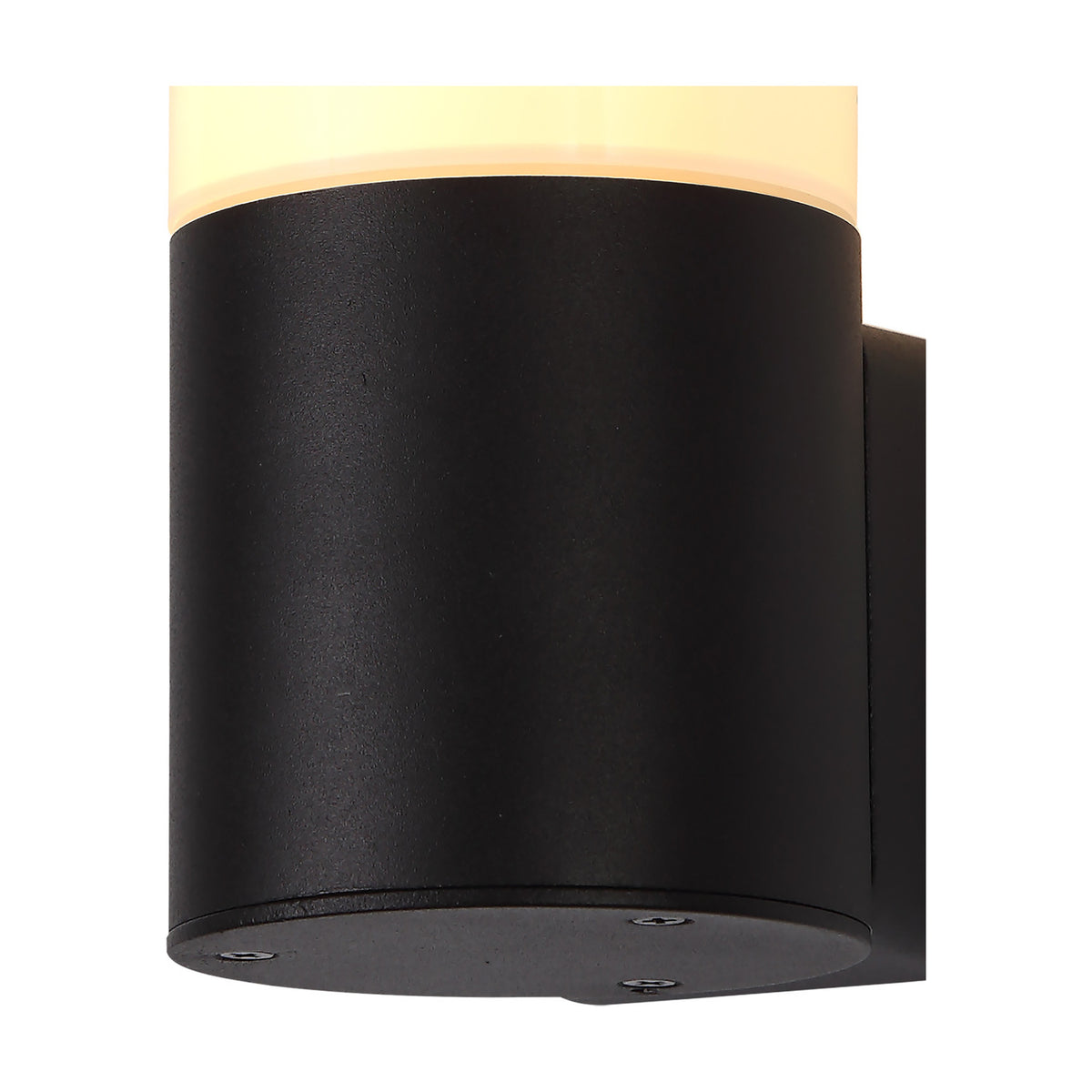 Prado E27 IP44 wall light in black, close-up of the cylindrical aluminium body with opal white shade lit warm, mounting plate visible, plain white background.