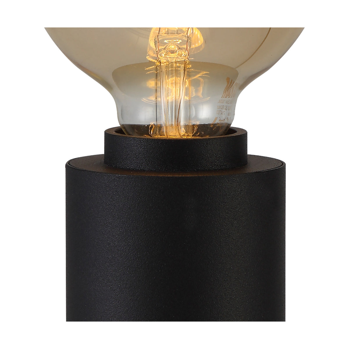 Close-up of the Delp E27 Table Lamp in sand black, showing the compact cylindrical iron base and open E27 holder fitted with a glowing globe bulb.