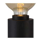 Close-up of the Delp E27 Table Lamp in sand black, showing the compact cylindrical iron base and open E27 holder fitted with a glowing globe bulb.