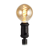 Kork E27 Table Lamp 60mm in black iron with an illuminated globe filament bulb and rotary switch, shown on a plain white background.