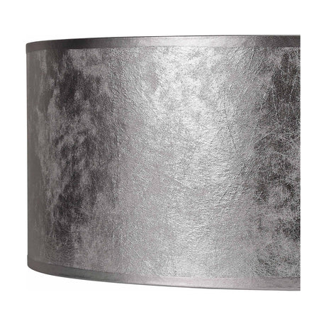 Close-up of the Sigma Cylinder Lamp Shade 50cm in silver leaf PVC, showing its textured, foil-effect finish with a soft fabric-bound edge trim.