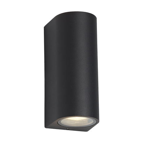 Tomar 2 Light Curved Outdoor Wall Light in sand black, cylindrical aluminium body with clear glass apertures at top and bottom, shown against a plain white background.