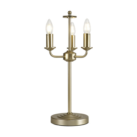 Banyan 3 Light E14 Table Lamp 24cm in champagne gold, iron candelabra-style base with three upright candle holders and exposed bulbs on a slim stem and round foot, shown on a plain white background.
