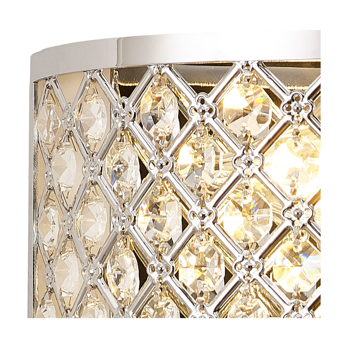 Close-up of the Sasha 2 Light E14 Wall Light in polished chrome, showing a lattice of clear crystal glass with illuminated candle bulbs glowing behind opal white diffusers.