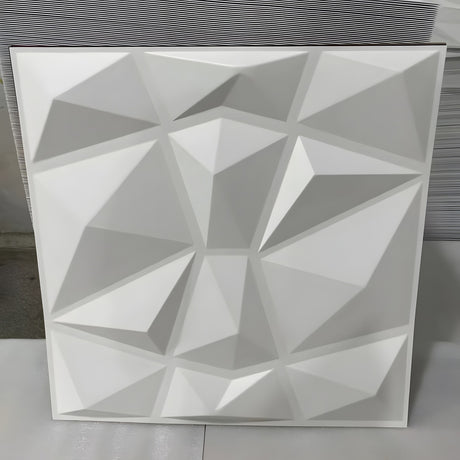 White PVC 3D wall panel, 50 x 50cm, with irregular pyramid facets in a geometric grid, shown upright against a plain light background.