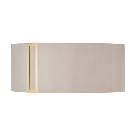 Sigma Lamp Shade 20cm High in Antique Brass, an oval drum-style fabric shade in light taupe with a slim vertical brass trim accent, shown on a plain white background.