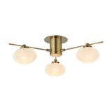 Addie 3 Light G9 Flush Ceiling Light in antique brass, 50cm, with three opal glass globe shades on angled arms from a round backplate, shown on a plain white background.