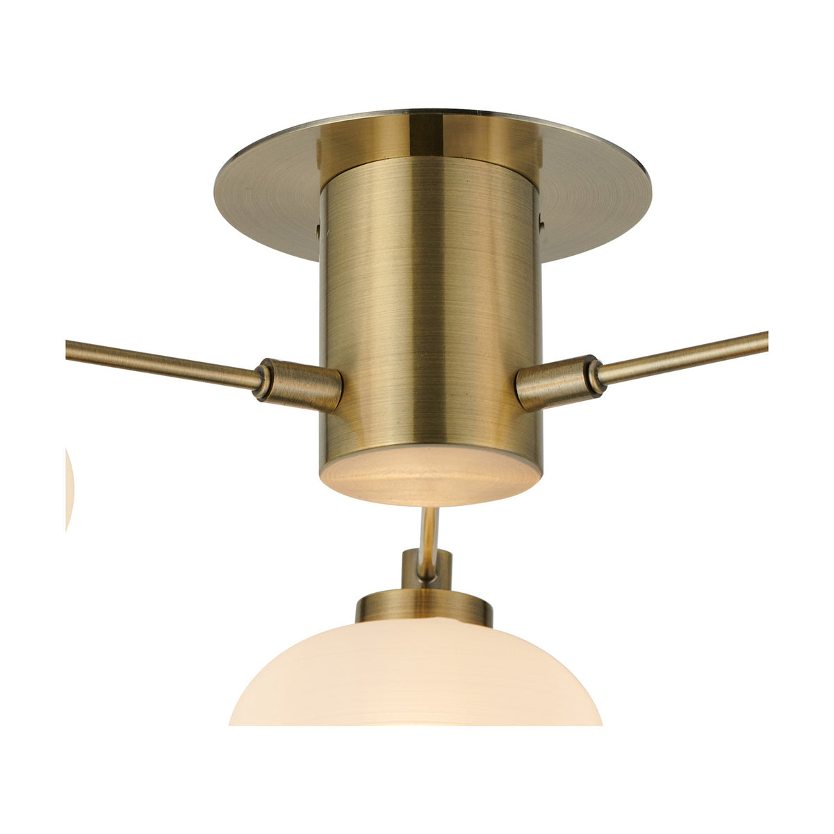 Addie 3 Light G9 Flush Ceiling Light 50cm in antique brass, close-up of the cylindrical centre with arms extending to opal glass globe shades, shown on a white background.