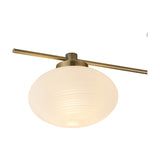 Addie 3 Light G9 Flush Ceiling Light 50cm in Antique Brass, showing one opal glass globe shade lit beneath a straight brass bar and central mount, on a white background.