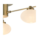 Close-up of the Addie 3 Light G9 Flush Ceiling Light in antique brass, showing opal glass globe shades on angled brass arms against a plain white background.