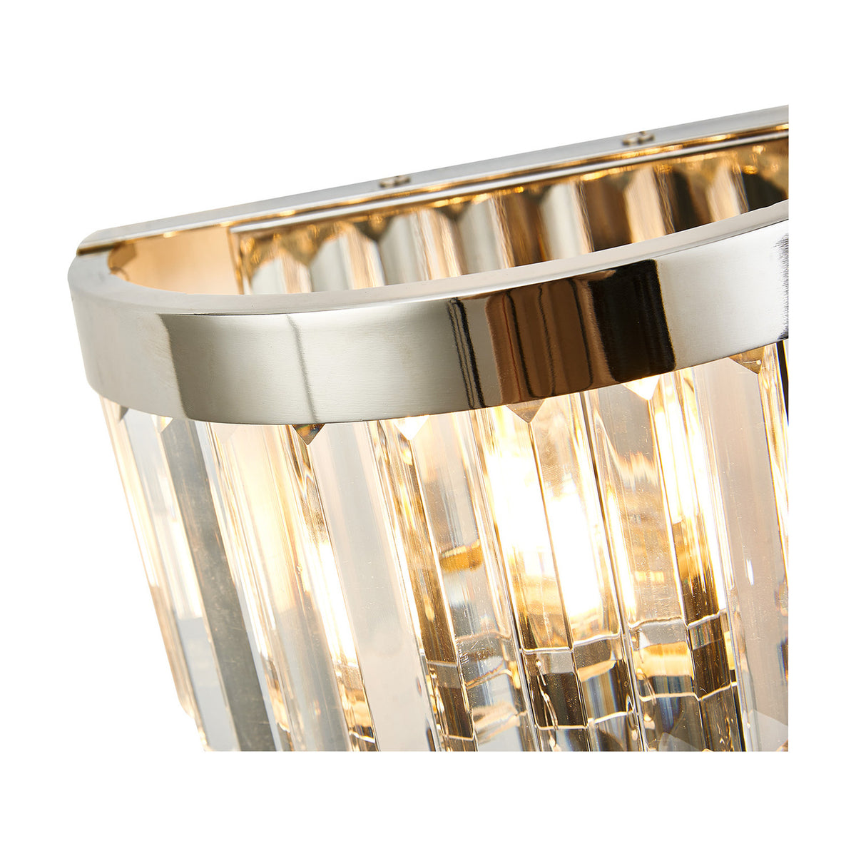 Close-up of the Cosette 2 Light E14 Wall Light in polished nickel, showing clear K9 crystal rods and curved metal frame with visible lamp glow, on a plain white background.