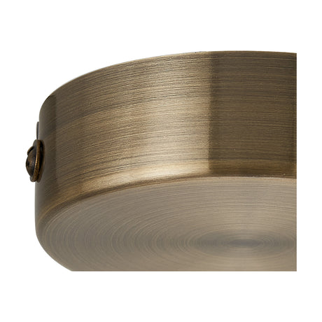 Close-up of the Hayes Round No-Hole Ceiling Rose 80mm in antique brass, showing its brushed cylindrical form, closed solid centre, and small fixing screw, against a plain white background.