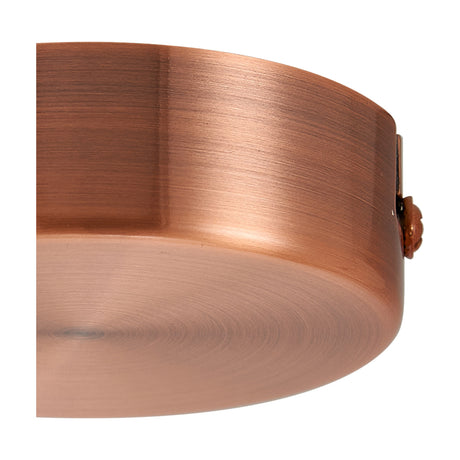 Close-up of the Hayes Round No-Hole Ceiling Rose 80mm in antique copper, showing its solid, unbroken disc face and brushed metallic finish against a plain background.