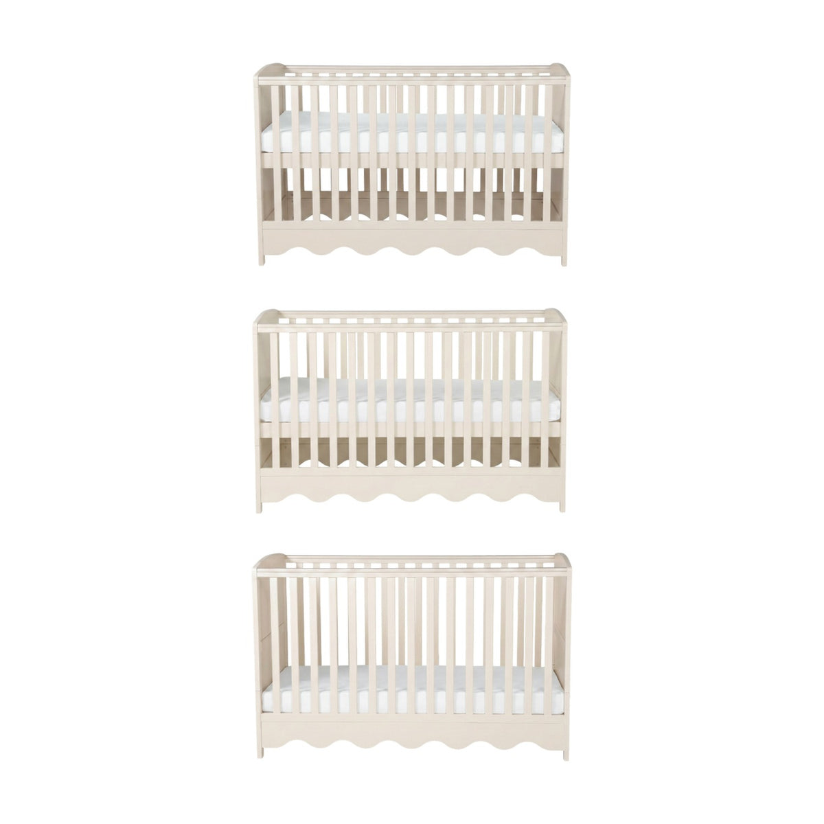 Dancer Convertible Cot Bed in cashmere finish, shown at three base height positions with slatted sides, teething rails, and scalloped bottom edge on a plain white background.