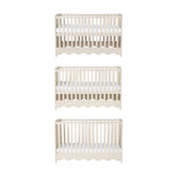 Dancer Convertible Cot Bed in cashmere finish, shown at three base height positions with slatted sides, teething rails, and scalloped bottom edge on a plain white background.