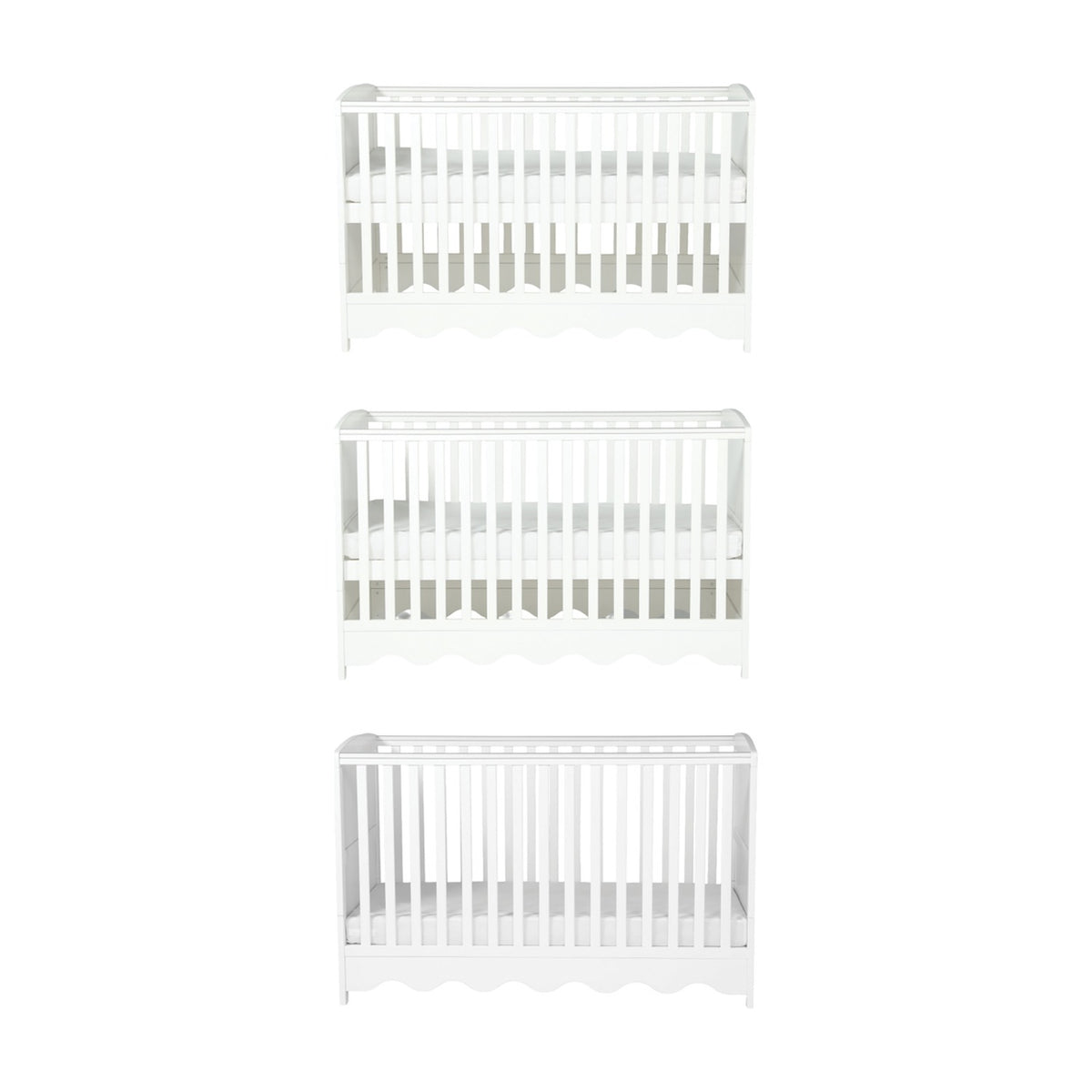 Dancer Convertible Cot Bed in white MDF, shown at three base height positions with slatted sides and scalloped bottom edge, on a plain white background.
