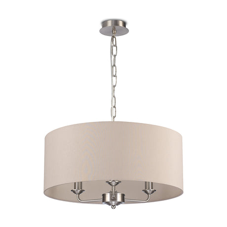 Banyan 3 Light E14 pendant light with satin nickel chain suspension and arms, wide nude beige faux silk drum shade, 50cm, on a plain white background.