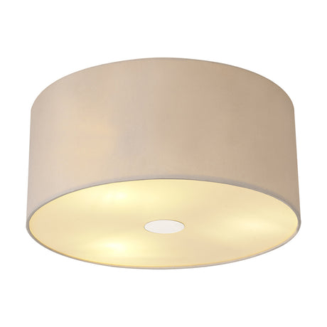 Baymont 3 Light Flush Ceiling Light in nude beige fabric drum shade with polished chrome frame, glowing frosted diffuser visible, shown on a plain white background.
