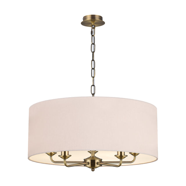 Banyan 5 Light E14 Pendant Light with wide nude beige drum shade and five arms on an antique brass stem and chain, shown on a plain white background.
