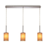 Baymont 3 Light Pendant, a linear polished chrome bar with three taupe fabric drum shades on cords, shown lit against a plain white background.