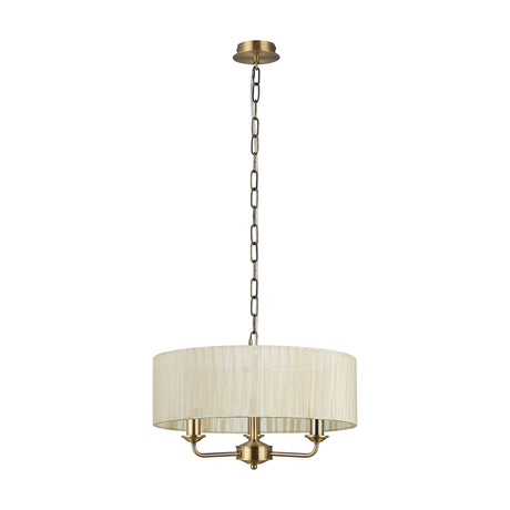 Banyan 3 Light E14 Pendant Light in cream with antique brass fittings, featuring a round drum shade on three curved arms, hung from a chain on a plain white background.