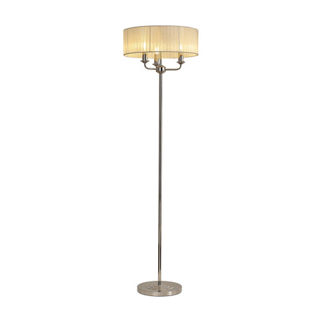 Banyan 3 Light E14 floor lamp with cream fabric drum shade on a polished nickel frame with three candle arms and slim base, shown on a white background.