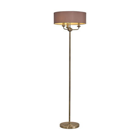 Banyan 3 Light E14 Floor Lamp with a wide taupe drum shade and gold lining atop three candle arms, slim antique brass stem and round base, shown on a plain white background.