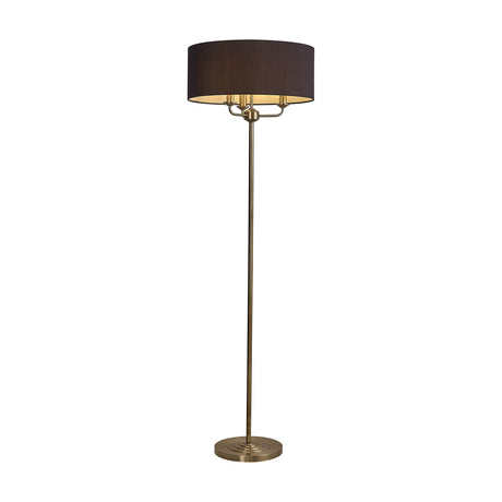 Banyan 3 Light E14 Floor Lamp with a wide black drum shade atop three candle-style arms on an antique brass stem and stepped base, shown on a plain white background.
