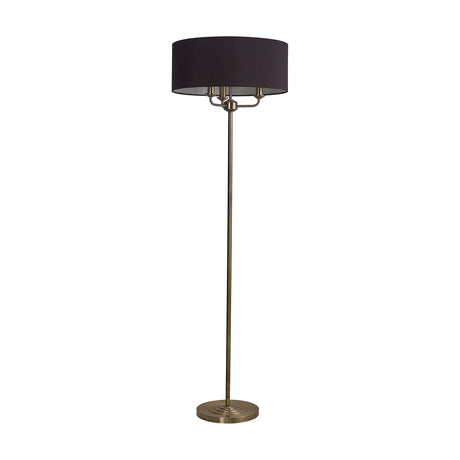 Banyan 3 Light E14 Floor Lamp with a wide black drum shade and antique brass stem and base, set on a plain white background.