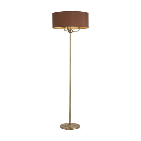 Banyan 3 Light E14 Floor Lamp with a wide raw cocoa fabric drum shade on an antique brass stem and round base, set against a plain white background.