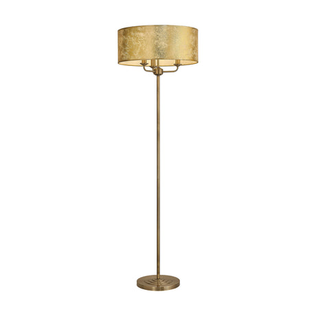 Banyan 3 Light E14 Floor Lamp with a wide gold foil drum shade, antique brass stem and round base, on a plain white background.