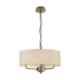 Banyan 3 Light Pendant Light in champagne gold with an ivory pearl fabric drum shade, hung from a chain link, shown on a plain white background.