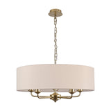 Banyan 5-light pendant with a 60cm nude beige faux silk drum shade, champagne gold ceiling plate and five curved candle arms, shown on a plain white background.