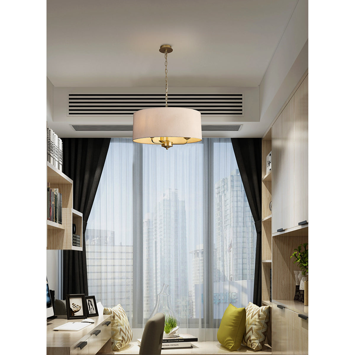 Banyan 3-light E14 pendant light with 50cm nude beige fabric drum shade and champagne gold frame, shown hanging above a desk in a home office setting.