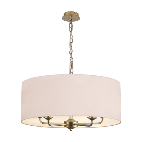 Banyan 5 light pendant with a wide nude beige drum shade and champagne gold arms and chain, shown on a plain white background.